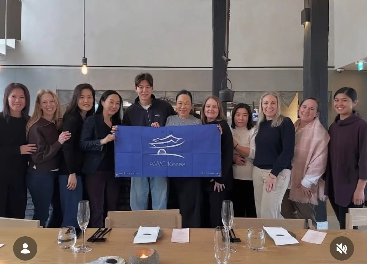 AWC Korea members holding an AWC Korea banner